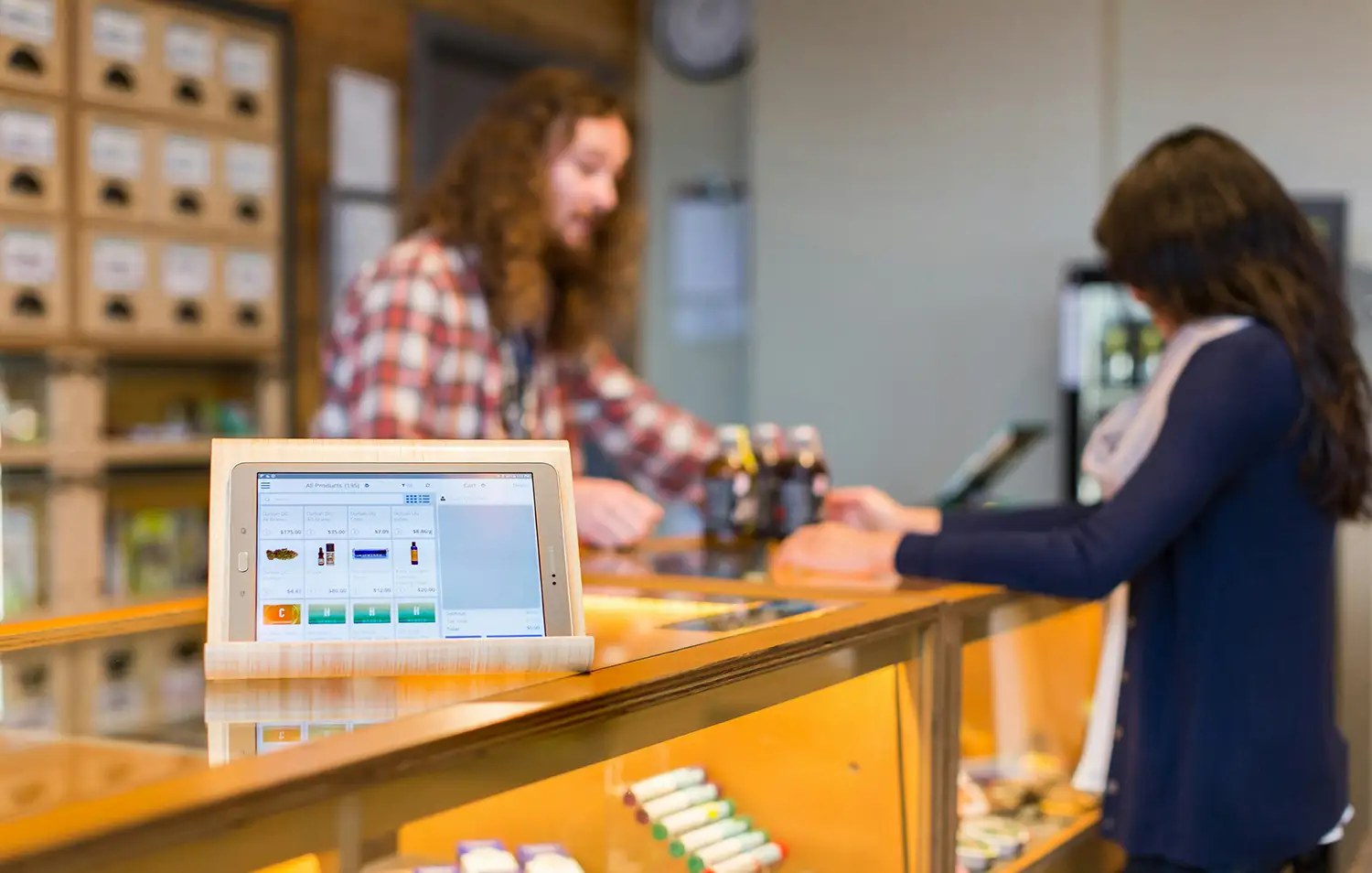 An image of two young people at a dispensary, which can be one of many high risk merchant accounts that are flagged on the MATCH list